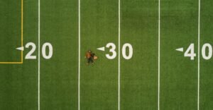 martin-reisch-unsplash -man lying in green soccer field