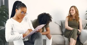 Professional discussing a career in Human Resources with employees in a modern workplace office.