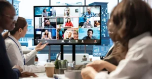 Hybrid workplace culture in action: team members collaborating from the office and from home on a video call